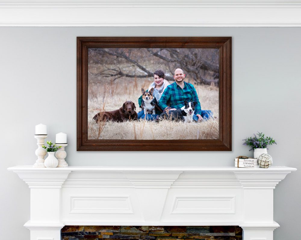 Family with dogs above fireplace