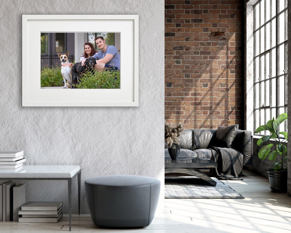 Family with dog portrait on wall