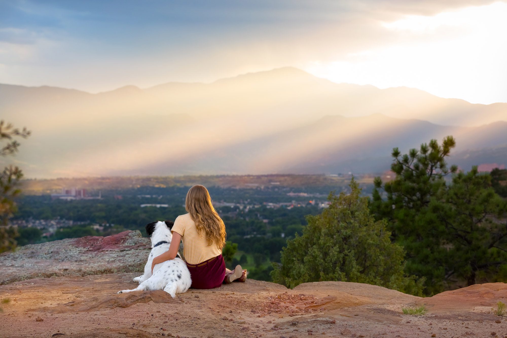Girl looking at Colorado Springs view with dog